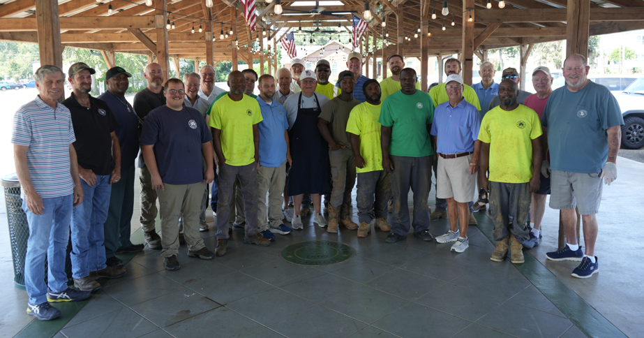 group of men standing at the farmers market side by side